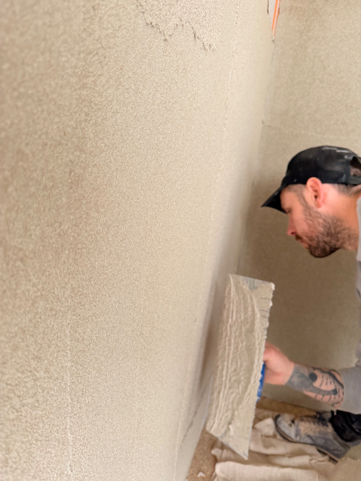Close-up of cork insulation being smoothed on an internal wall