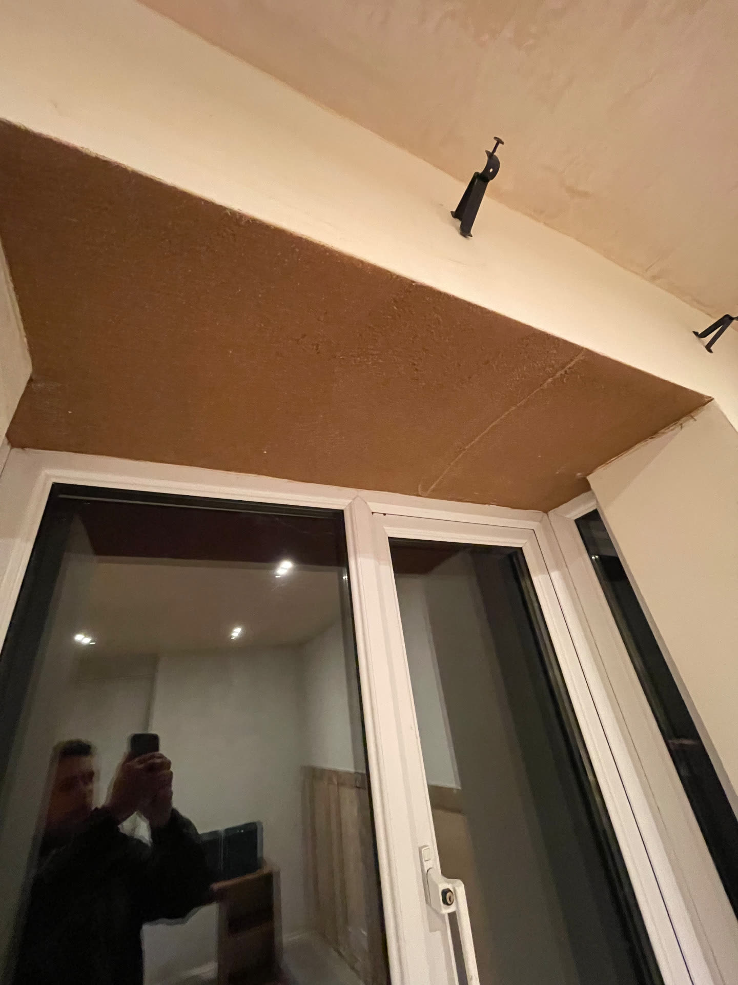 Cork insulation taken across the window head and reveal of a bay window
